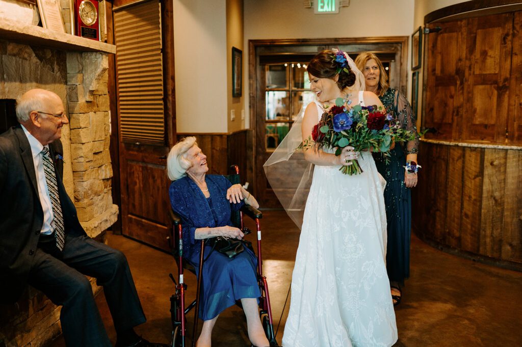 An emotional, documentary-style photo of a bride sharing a laugh with her grandmother, highlighting the importance of authentic moments when choosing your photographer.