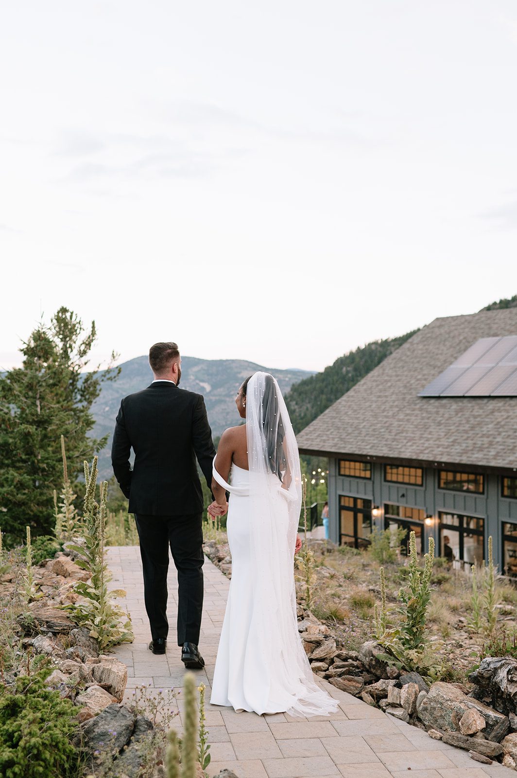 bride and groom walking towards their north star gatherings wedding reception area