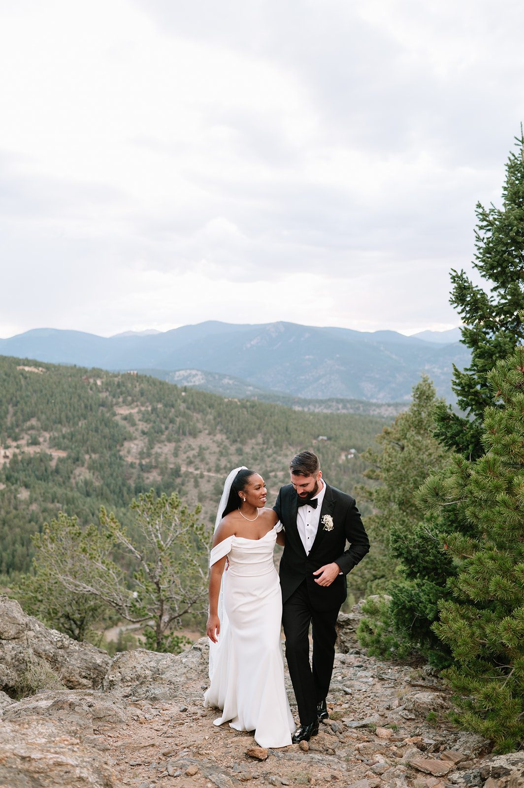 bride and groom walking up a path during their north star gatherings photoshoot 