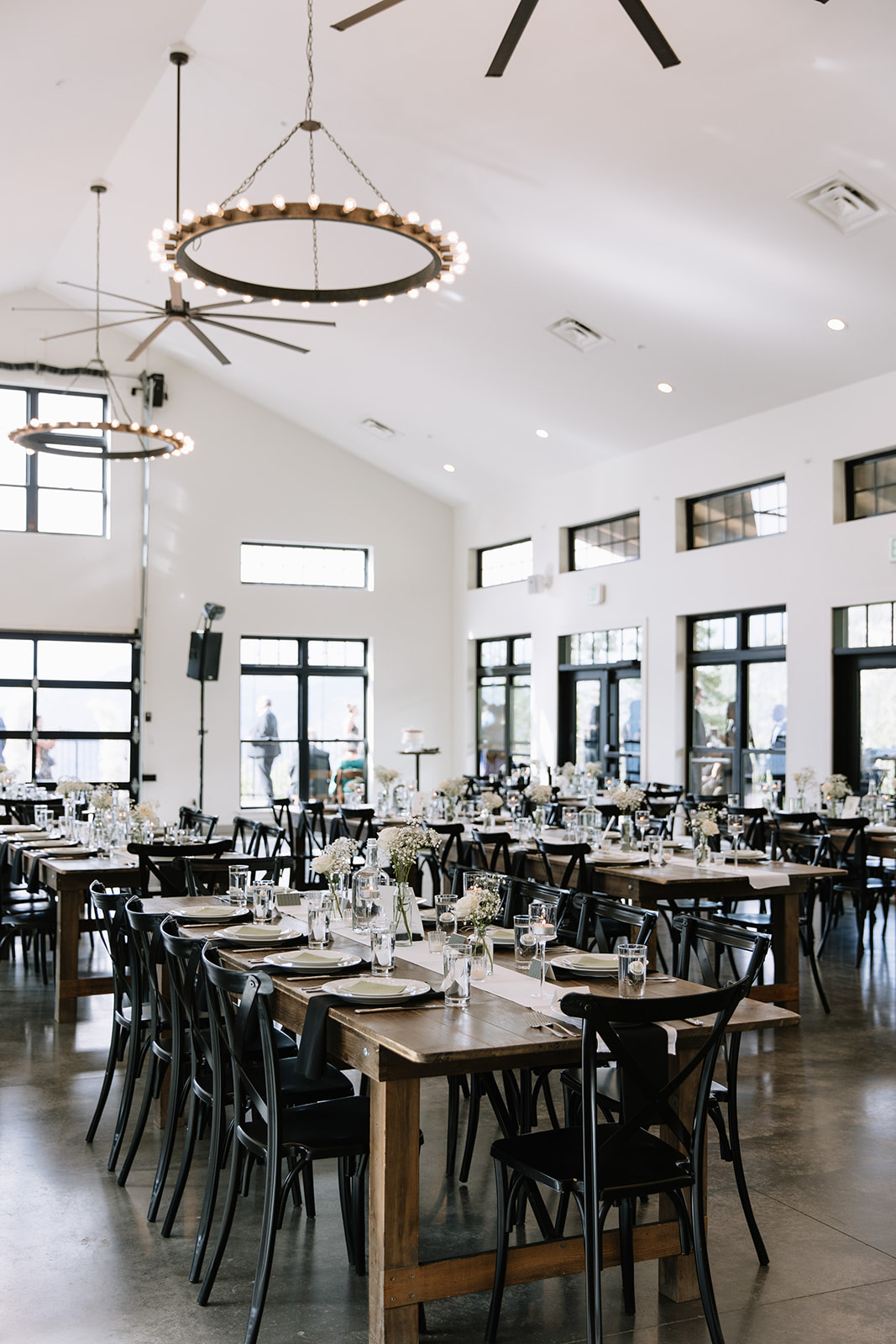 long tables set up for a wedding at north star gatherings idaho springs co in the reception area