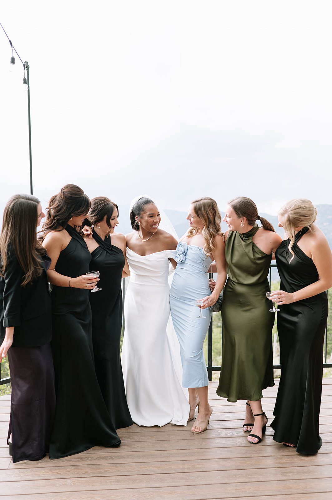 bride and her bridesmaids sharing a joy filled moment at north star gatherings colorado